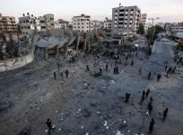 Palestinians inspect the remains of a building that was destroyed during Israeli airstrikes on Gaza City, on May 5, 2019