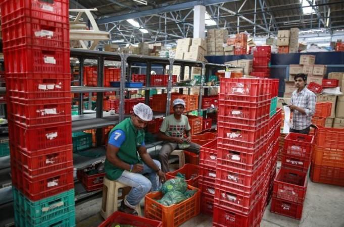 Employees sort out orders before sending them out at a Big Basket warehouse on the outskirts of Mumbai Bigbasket