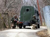 Soldiers take position during a gun-battle with militants at Rehmatabad village in Jammu and Kashmir's Sopore district on Feb 21, 2015.