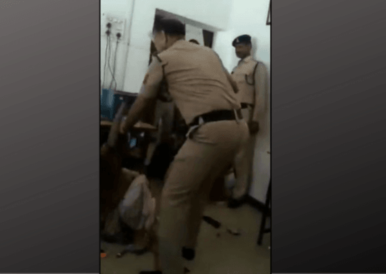 policeman beating woman