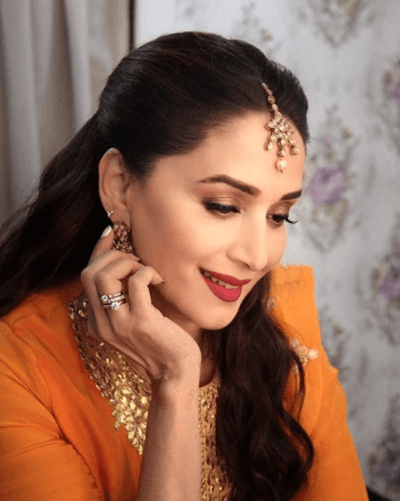 Madhuri Dixit in orange traditional outfit. Madhuri Dixit in orange