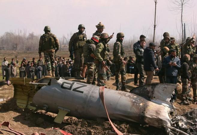 Indian soldiers stand next to the wreckage of an Indian Air Force helicopter after it crashed in Budgam district in Kashmir, February 27. REUTERS/Danish Ismail