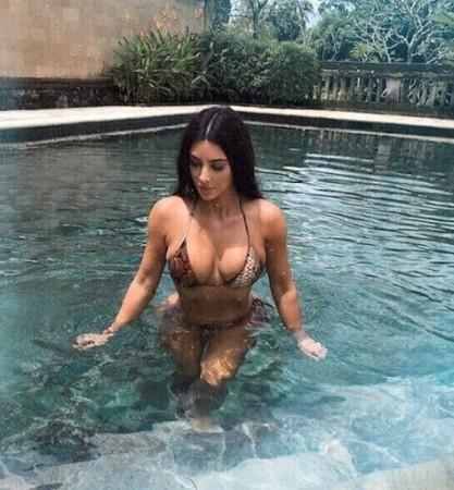 Kim Kardashian showcases her figure in barely there bikinis from