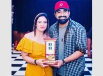 Muskan Narang receiving an award from a celeb