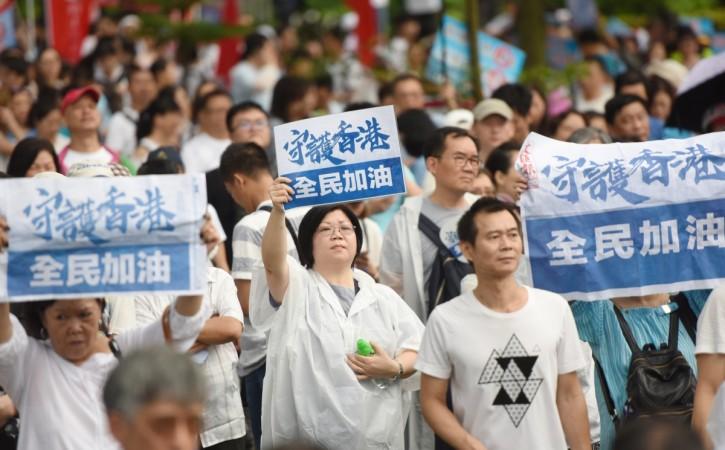 Local residents hold banners during the Hong Kong protests