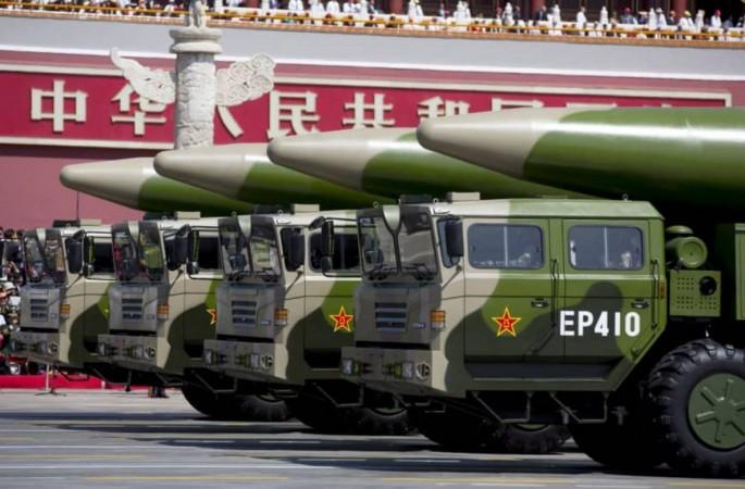 Chinese military vehicles carrying DF-26 ballistic missiles travel in Beijing's Tiananmen Square during a military parade on September 3, 2015. China missile