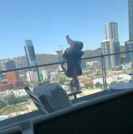 woman hanging of balcony
