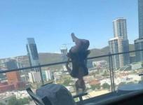 woman hanging of balcony