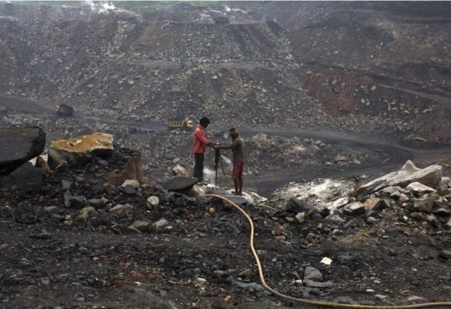 Workers drill at an open cast coal field at Dhanbad district in Jharkhand September 18, 2012. coal field at Dhanbad district, Jharkhand