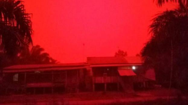 A red haze cloaks a village in the Indonesian province of Jambi. Smoke from fires lit by farmers to clear undergrowth for new crop is causing the haze that is hanging over large areas of Indonesian provinces. Red haze in Indonesia