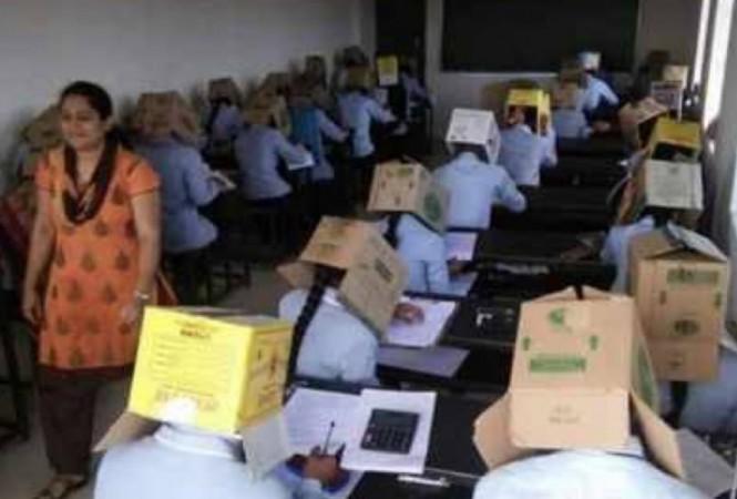 Students of Bhagat PU College in Karnataka writing with cardboards on their heads during exams to prevent them from copying Bhagat PU College