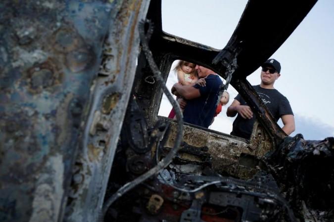 Relatives of slain members of Mexican-American families belonging to Mormon communities react next to the burnt wreckage of a vehicle where some of their relatives died, in Bavispe, Sonora state, Mexico November 5, 2019. Mexican cartel ambush kills 9 Mormons