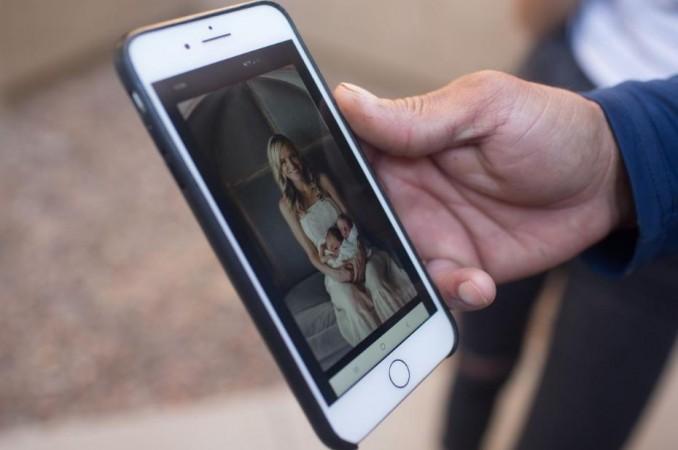 Aaron Staddon shows a photo of his Mormon relatives in the Mexican-American LeBaron family - Rhonita Miller, holding Titus Alvin Miller, 8 months, and Tiana gricel Miller, 8 months - all three of whom were killed in Mexico, in Queen Creek, Arizona, US November 5. 2019. Rhonita Miller