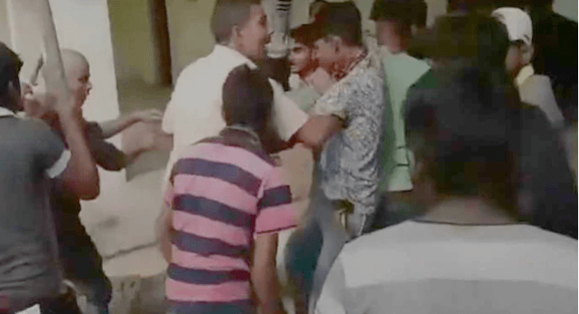 Image: Video grab of students thrashing their teacher at the premises of Aaadarsh Janata Inter College, UP (ANI) UP Teacher trashed