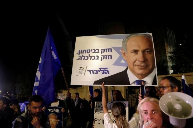 Supporters of Israeli Prime Minister Benjamin Netanyahu protest outside his residence following Israel's Attorney General Avichai Mandelblit's indictment ruling. Netanyahu