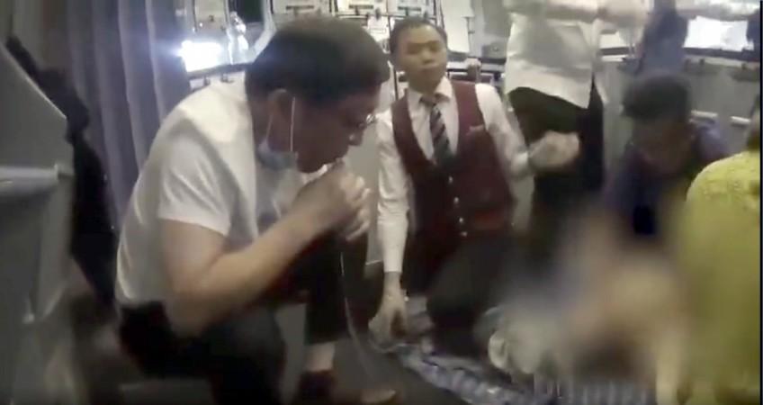 A doctor has been hailed for saving an elderly man's's life by sucking urine from his bladder during mid-flight. urine bladder doctor