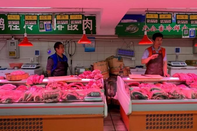 Pork vendors' stalls at a market in Beijing, China. US China