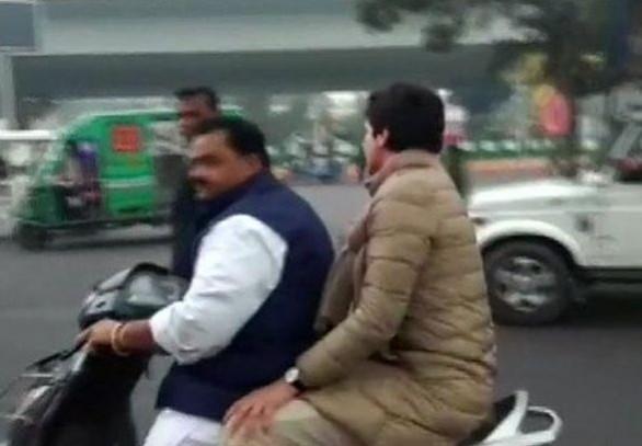 Lucknow: Congress General Secretary Priyanka Gandhi Vadra being driven on a scooty by party leader Dheeraj Gurjar after the police tried to block her way to the retired activist IPS officer S R Darapuri's residence, in Lucknow on Dec 28, 2019. Priyanka's carcade was stopped twice -- at 1090 Square and then the polytechnic square on Saturday Lucknow: Congress General Secretary Priyanka Gandhi Vadra being driven on a scooty by party leader Dheeraj Gurjar after the police tried to block her way to the retired activist IPS officer S R Darapuri's residence, in Lucknow on Dec 28, 2019. Priyanka's