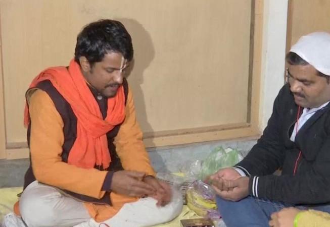 A Hindu priest is seen offering prayers and doing Delhi house