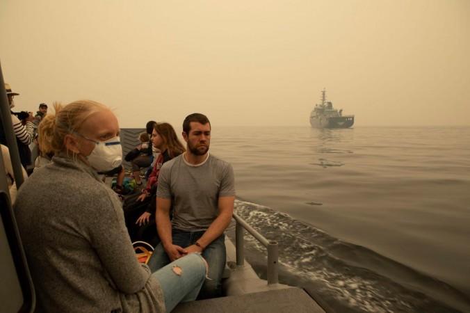Evacuees being transported by landing craft to MV Sycamore at Mallacoota, Australia. Australia bush fire