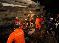 A rescue team searches for trapped workers at a collapsed building, which was under construction in Kep, Cambodia January 3, 2020.