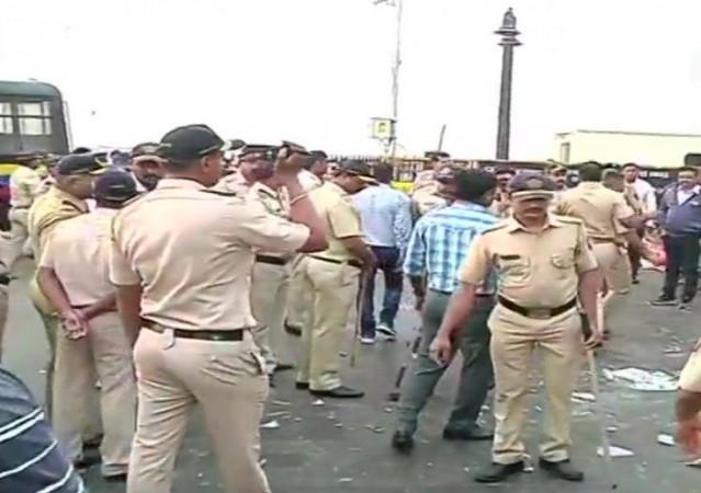 Police evacuates protesters from the Gateway of India in Mumbai. Mumbai protests