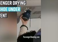 Passenger drying his shoes under air vent