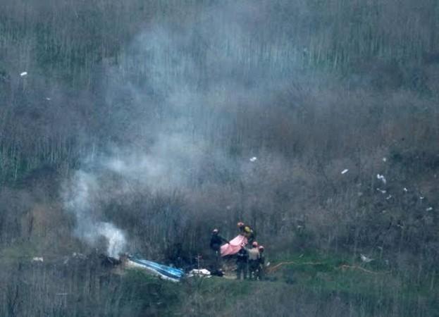 Law enforcement officers investigate the scene of the helicopter crash that killed Kobe Bryant. Kobe Bryant helicopter crash