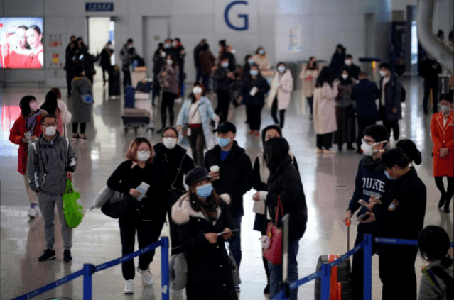 Passengers wearing mask at the airport. Reuters Coronavirus