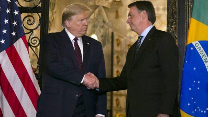 Brazilian President Jair Bolsonaro shakes hands with US President Donald Trump President