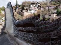 A border wall divides Nogales, Arizona from the Mexican state of Sonora