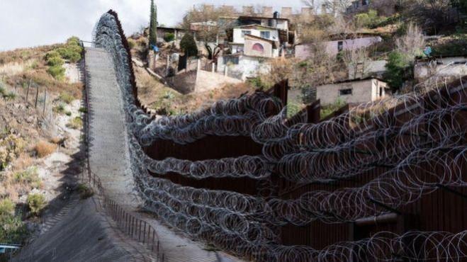 A border wall divides Nogales, Arizona from the Mexican state of Sonora