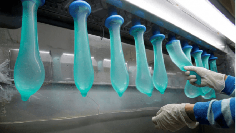 A worker performing a test on condoms at Malaysia's Karex condom factory in Pontian, 320 km southeast of capital Kuala Lumpur, on November 7, 2012