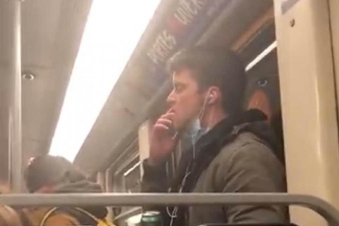 train passenger licks the pole