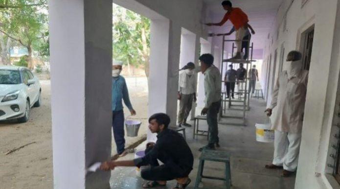 Migrant labourers in Sikar painting a school Sikar