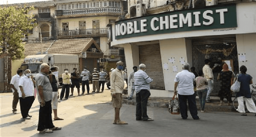people maintaining distancing in queue