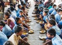 School children eating millet during a pilot feeding trial (before COVID-19)