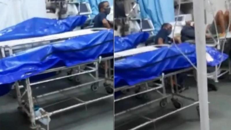 Screengrab of the video showing bodies wrapped in blue plastic next to patients undergoing treatment. KEM Hospital bodies next to patients