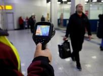 FILE PHOTO: A Kazakh sanitary-epidemiological service worker uses a thermal scanner to detect travellers who may have symptoms possibly connected with the coronavirus at Almaty International Airport, Kazakhstan January 21, 2020. REUTERS/Pavel Mikheyev/Fil