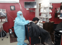 hair dresser in PPE suit