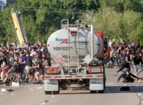 A tanker truck drove into a throng of protesters on a closed interstate near Minneapolis on Sunday, with the driver pulled from his rig and beaten, as major U.S. cities imposed curfews in fear of another night of demonstrations against police brutality de