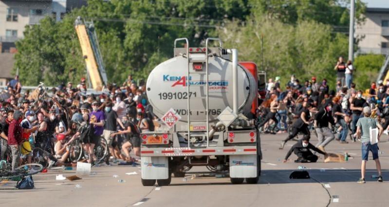 A tanker truck drove into a throng of protesters on a closed interstate near Minneapolis on Sunday, with the driver pulled from his rig and beaten, as major U.S. cities imposed curfews in fear of another night of demonstrations against police brutality descending into violence. A tanker truck drove into a throng of protesters on a closed interstate near Minneapolis on Sunday, with the driver pulled from his rig and beaten, as major U.S. cities imposed curfews in fear of another night of demonstrations against police brutality de