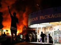 People watch as a Wendy's burns following a rally against racial inequality and the police shooting death of Rayshard Brooks, in Atlanta, Georgia, U.S. June 13, 2020. REUTERS/Elijah Nouvelage