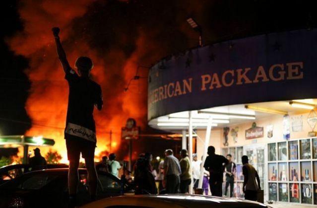 People watch as a Wendy's burns following a rally against racial inequality and the police shooting death of Rayshard Brooks, in Atlanta, Georgia, U.S. June 13, 2020. REUTERS/Elijah Nouvelage People watch as a Wendy's burns following a rally against racial inequality and the police shooting death of Rayshard Brooks, in Atlanta, Georgia, U.S. June 13, 2020. REUTERS/Elijah Nouvelage