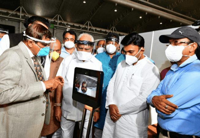 CM Yediyurappa inspects LED robots at the centre Karnataka CM Yediyurappa visits BIEC