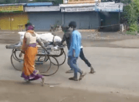 Wife pushes dead husband's body on a cart