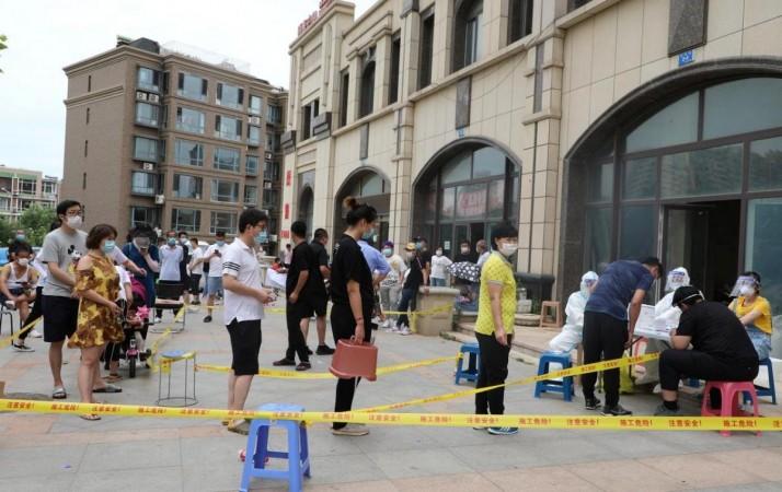 Residents wearing face masks line up to receive nucleic acid tests after new cases of coronavirus disease (COVID-19) were confirmed in Dalian, Liaoning province, China July 26, 2020. cnsphoto via REUTERS Residents wearing face masks line up to receive nucleic acid tests after new cases of coronavirus disease (COVID-19) were confirmed in Dalian, Liaoning province, China July 26, 2020. cnsphoto via REUTERS