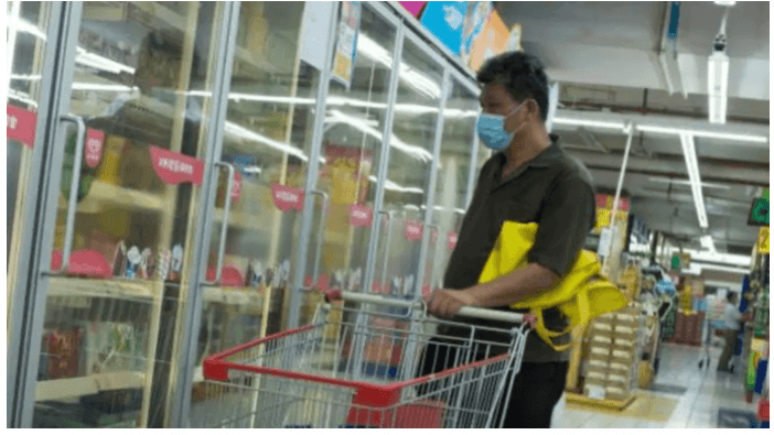 A man looks at frozen food products in a supermarket following an outbreak of the coronavirus disease in Beijing, China, August 13. frozen food