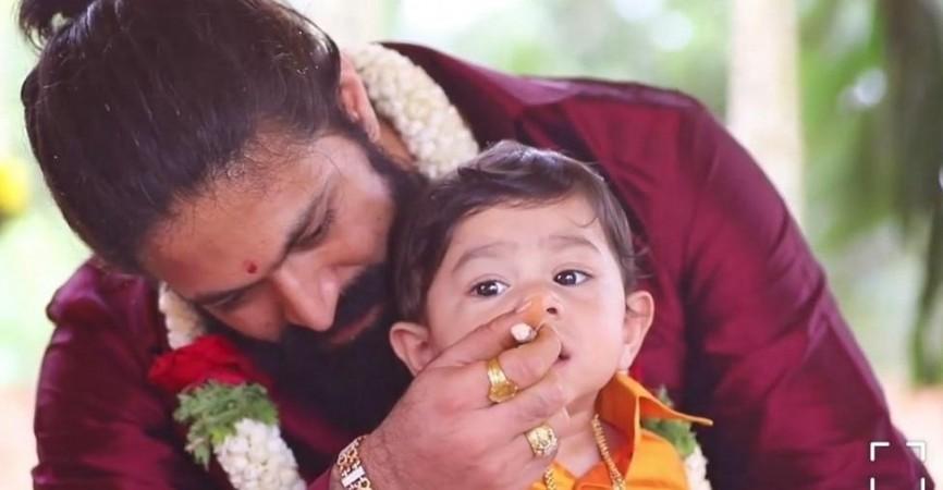 Yash busy with a ritual at his son Yatharv's naming ceremony. Yash with his son Yatharv