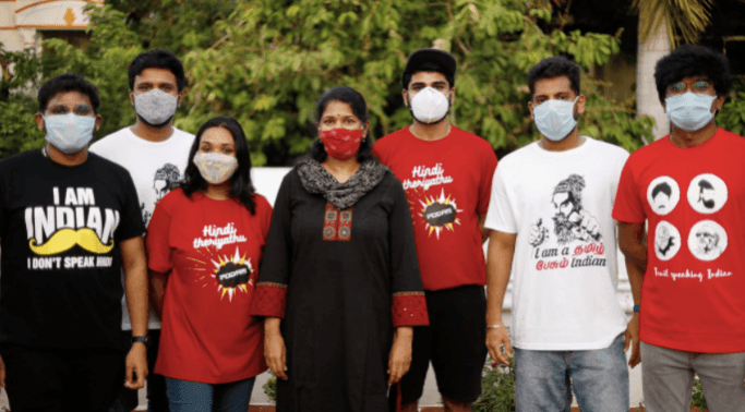Kanimozhi stands with youth wearing anti-Hindi imposition shirts (Photo: @KanimozhiDMK/Twitter) Anti-Hindi imposiiton shirts